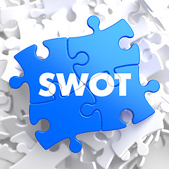 Image showing SWOT on Blue Puzzle Pieces. Business Concept.