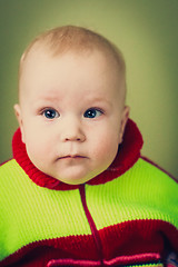 Image showing Portrait Of Sad Baby Boy On Green Background