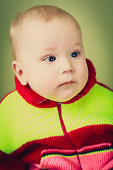 Image showing Portrait Of Sad Baby Boy On Green Background