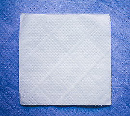 Image showing Paper Napkin On Blue Napkin Background