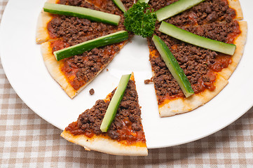 Image showing Turkish beef pizza with cucumber on top