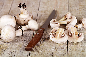 Image showing  fresh sliced champignons and old knife