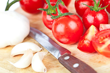 Image showing fresh tomatoes, garlic and old knife