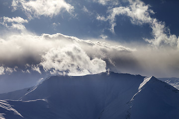Image showing Mountains in evening and sunlit clouds