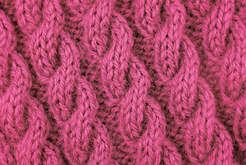 Image showing Closeup of pink cable stitch knitting