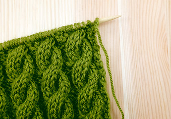 Image showing Green cable knitting stitch on the needle