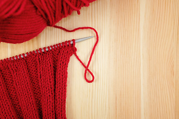 Image showing Red knitting in rib stitch with a ball of yarn