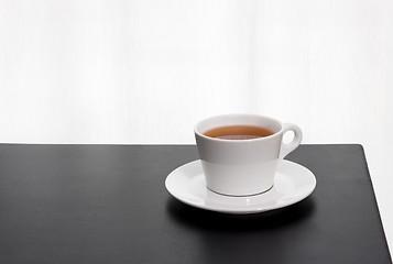 Image showing Cup of tea on a black table