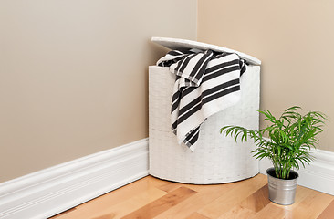 Image showing Laundry basket and plant in the room corner