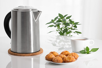 Image showing Electric kettle, teacup and cookies