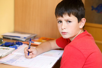 Image showing tired and bored boy doing school homework