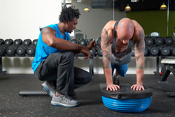 Image showing Man with trainer in gym