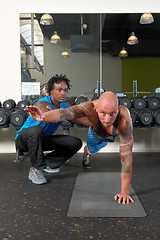 Image showing Man with trainer in gym