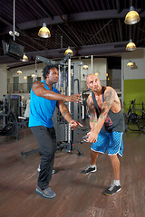 Image showing Man with trainer in gym