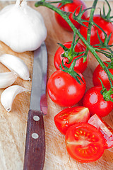 Image showing fresh tomatoes, garlic and old knife