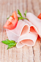 Image showing slices of ham with parsley and tomato 