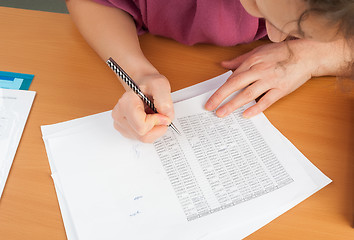 Image showing Woman writing in organizer