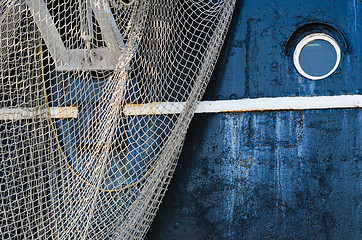 Image showing Window of the ship and hanging down networks, close up