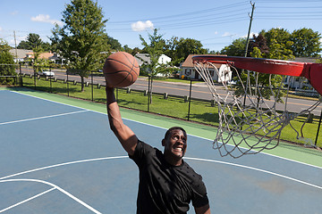 Image showing Man Dunking a Basketball