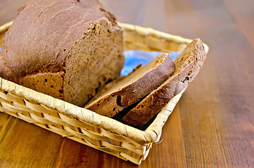 Image showing Rye homemade bread in a wicker basket on the board