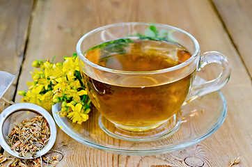 Image showing Herbal tea from tutsan in strainer with cup