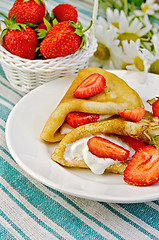 Image showing Pancakes with strawberries and basket with berries on a napkin