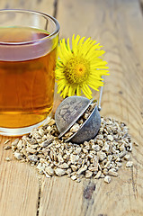 Image showing Herbal tea from the root of elecampane in a strainer with a mug