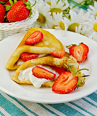 Image showing Pancakes with strawberries and daisies on a napkin