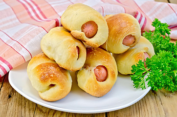Image showing Sausage rolls on a plate with parsley