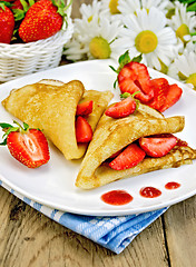 Image showing Pancakes with strawberries and jam on the board