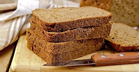Image showing Rye homemade bread stacked with a knife on a board