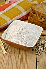 Image showing Flour rye in a bowl with bread and ears rye