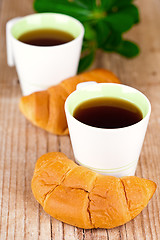 Image showing two cups of tea and fresh croissants 