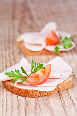 Image showing bread with sliced ham, fresh tomatoes and parsley