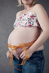 Image showing pregnant woman with ribbon around her tummy