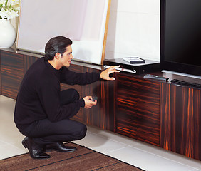 Image showing man using dvd player