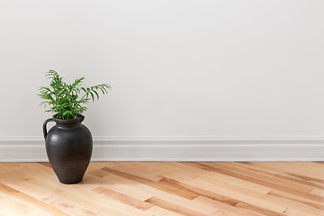 Image showing Amphora with green plant decorating a room