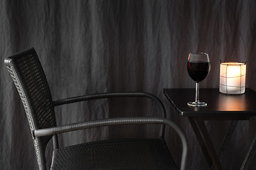 Image showing Lantern decorating a table with glass of wine