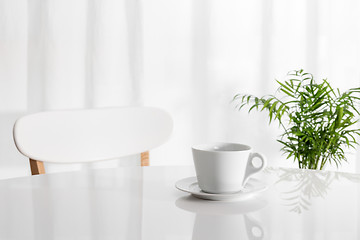 Image showing White cup on the kitchen table