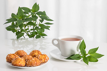 Image showing Tea, mint and tasty cookies