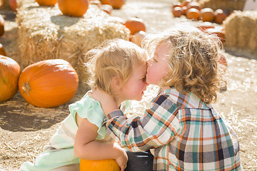 Image showing Sweet Little Boy Kisses His Baby Sister at Pumpkin Patch
