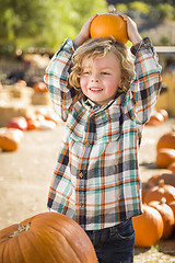 Image showing Little Boy Holding His Pumpkin at a Pumpkin Patch
