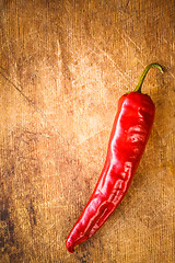 Image showing Red peppers on old wooden table