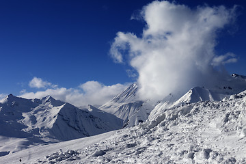 Image showing Snowdrift, ski slope and beautiful snowy mountains