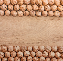 Image showing Unshelled Walnuts Lying On Desk
