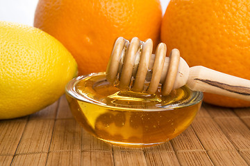 Image showing fresh honey with lemon and orange fruits