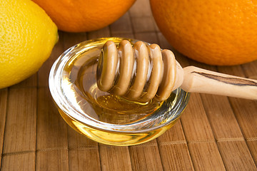 Image showing fresh honey with lemon and orange fruits