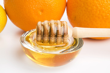 Image showing fresh honey with lemon and orange fruits