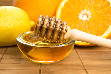 Image showing fresh honey with lemon and orange fruits