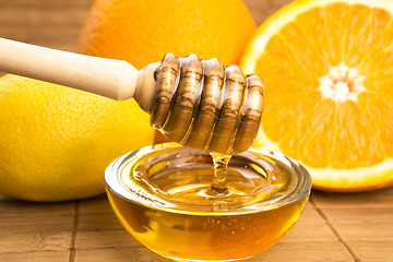 Image showing fresh honey with lemon and orange fruits